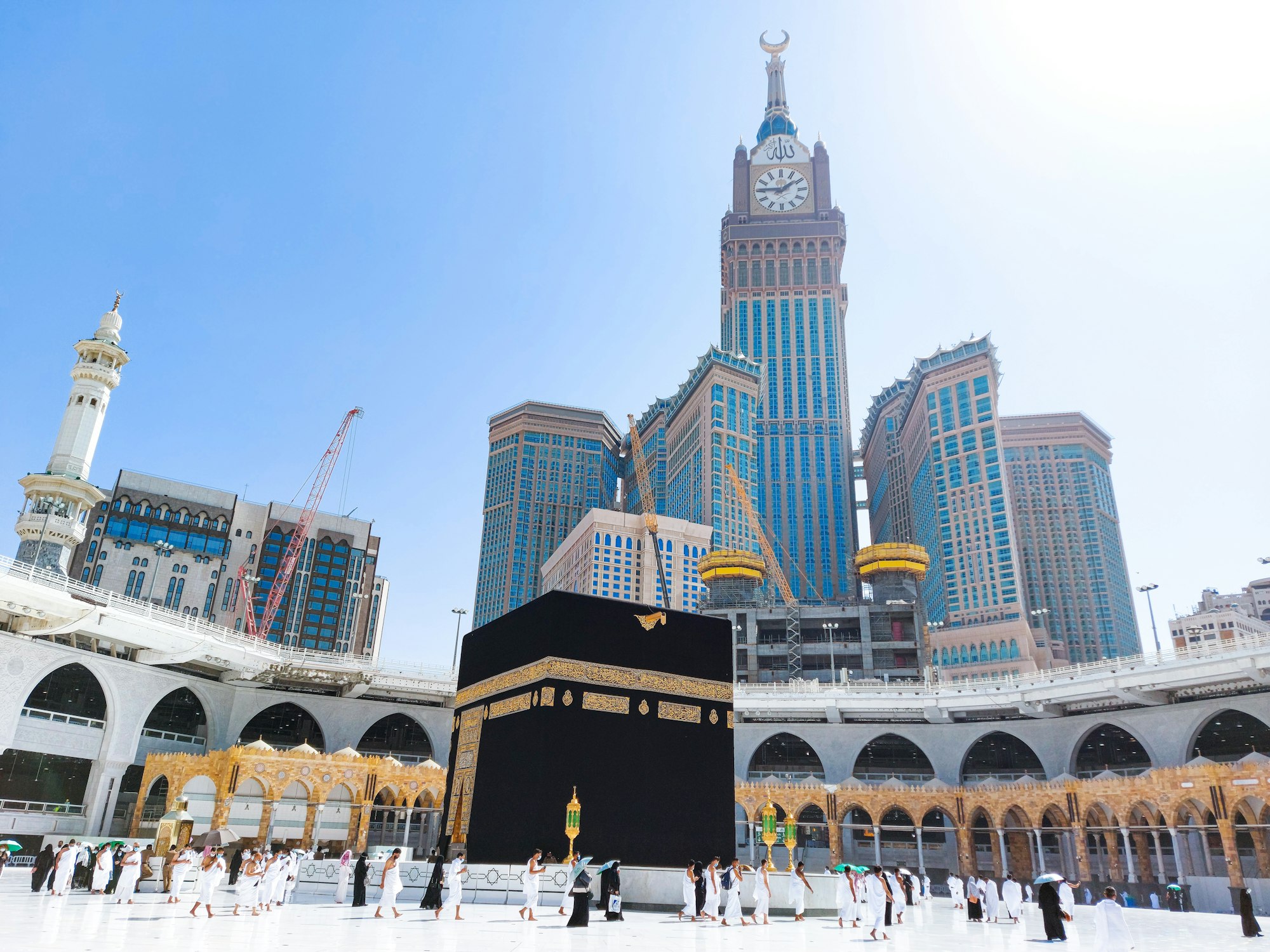 Pilgrims in Kaaba in Macca al Haram - umrah Socially Distanced coronavirus restrictions face mask